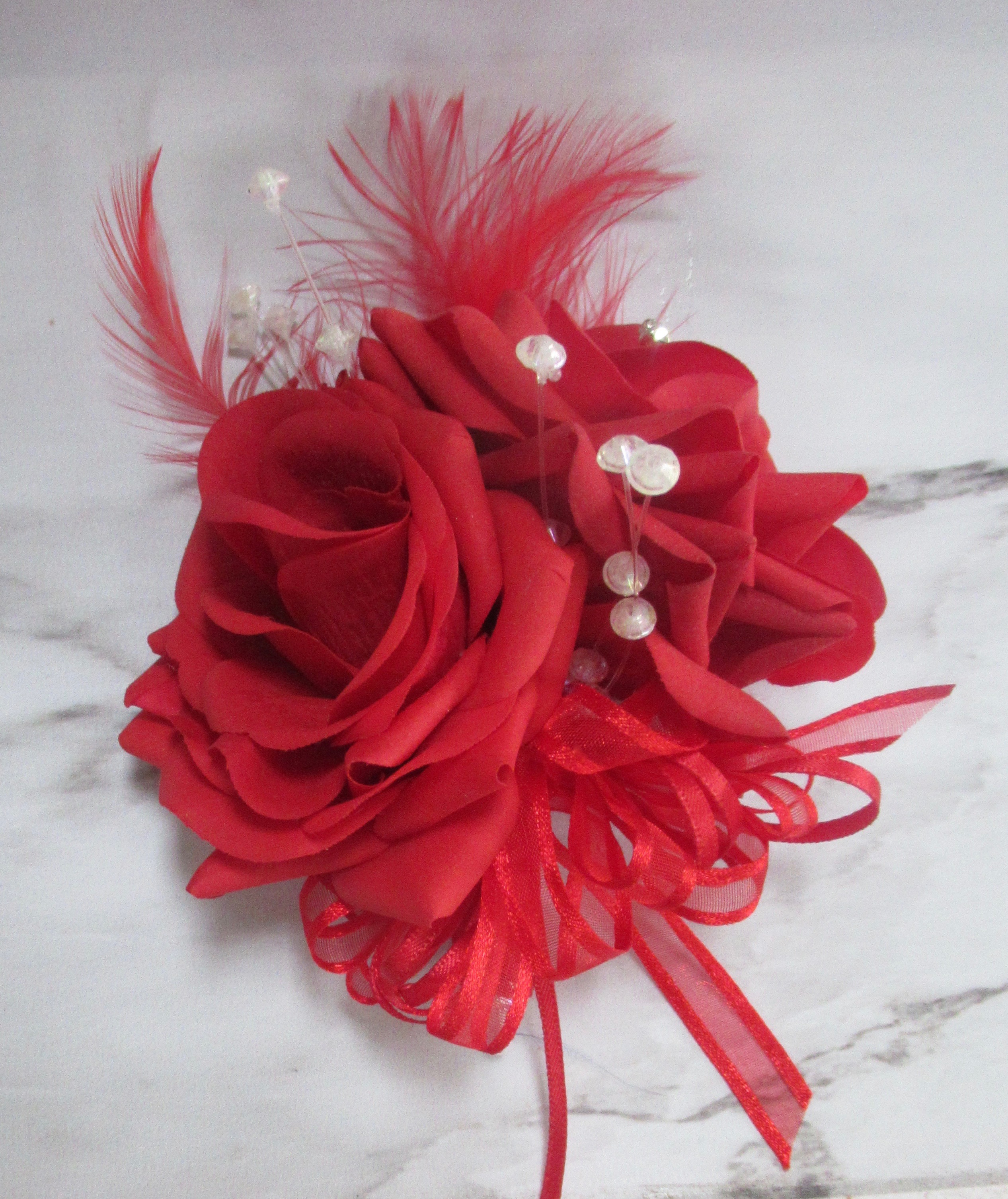 red feather corsage, red gardenia corsage for weddings